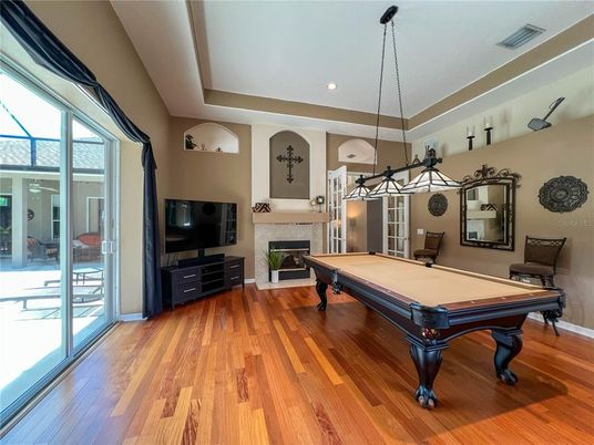 Billiard Table, Chandelier, Fireplace, Game Room, Interior, Pendant Lights, Recessed Lighting, Wood Texture Flooring