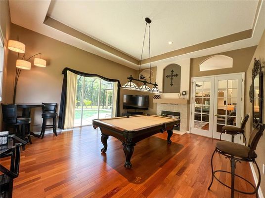 Billiard Table, Chandelier, Fireplace, Game Room, Interior, Pendant Lights, Recessed Lighting, Wood Texture Flooring