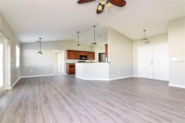 Empty room, Interior, Kitchen, Pendant Lights, Stainless Steel Appliances, Wood Texture Flooring