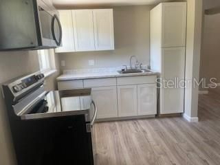 Interior, Kitchen, Recessed Lighting, Tile Countertops, Wood Texture Flooring