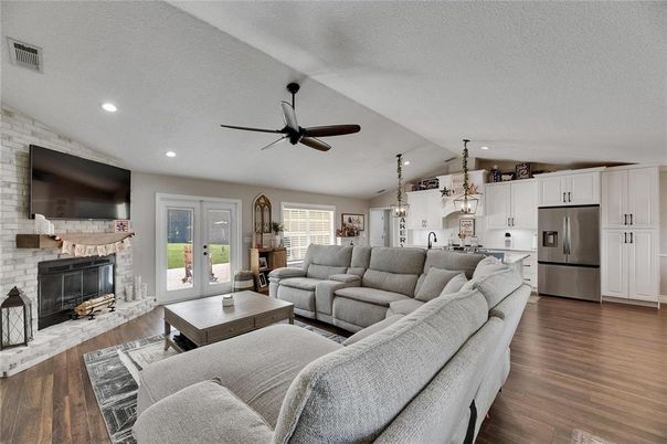 Fireplace, Interior, Kitchen, Living room, Pendant Lights, Recessed Lighting, Stainless Steel Appliances, Stone Walls, Wood Texture Flooring