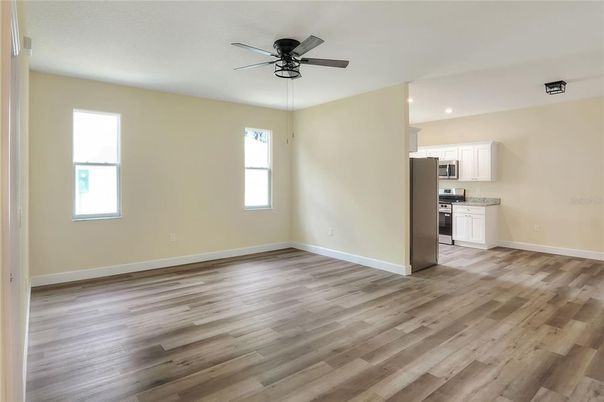 Empty room, Interior, Kitchen, Recessed Lighting, Stainless Steel Appliances, Wood Texture Flooring