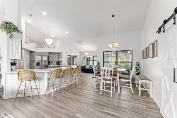 Chandelier, Dining room, Interior, Kitchen, Pendant Lights, Recessed Lighting, Stainless Steel Appliances, Wood Texture Flooring