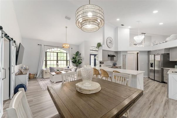 Chandelier, Dining room, Interior, Kitchen, Living room, Pendant Lights, Recessed Lighting, Stainless Steel Appliances, Wood Texture Flooring