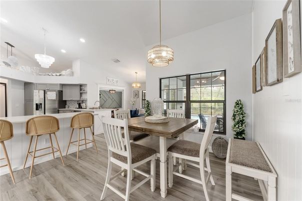 Chandelier, Dining room, Interior, Kitchen, Pendant Lights, Recessed Lighting, Stainless Steel Appliances, Wood Texture Flooring