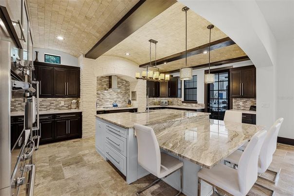 Chandelier, Interior, Kitchen, Pendant Lights, Recessed Lighting, Stainless Steel Appliances, Stone Walls
