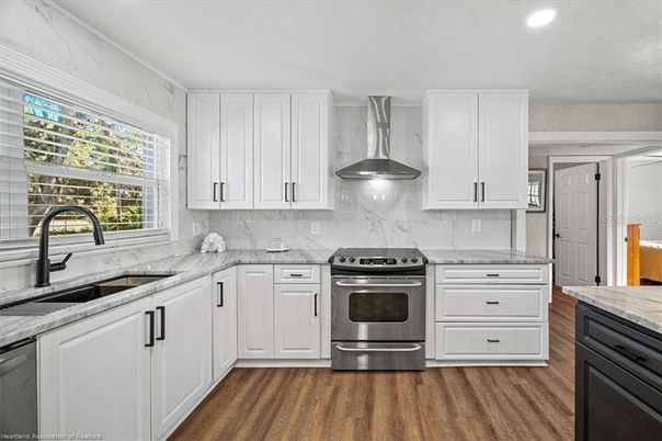 Interior, Kitchen, Marble Walls, Recessed Lighting, Stainless Steel Appliances, Wood Texture Flooring
