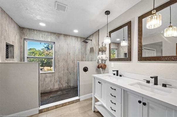 Bathroom, Dual Sink Vanities, Glass Shower, Interior, Pendant Lights, Recessed Lighting, Wood Texture Flooring