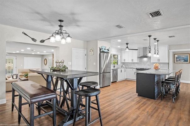 Dining room, Interior, Kitchen, Pendant Lights, Recessed Lighting, Stainless Steel Appliances, Wood Texture Flooring