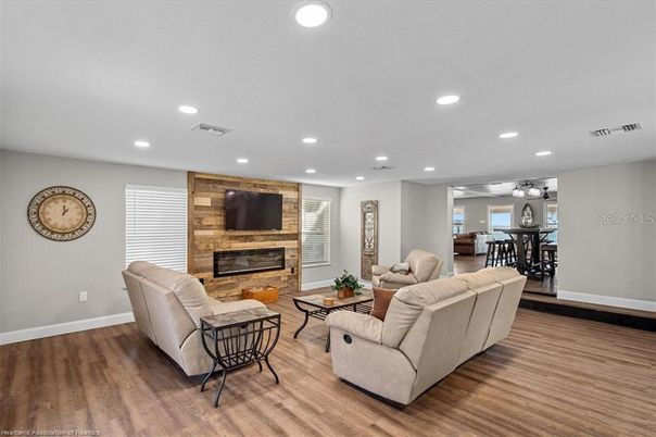 Dining room, Fireplace, Interior, Living room, Recessed Lighting, Stone Walls, Wood Texture Flooring, Wooden Walls