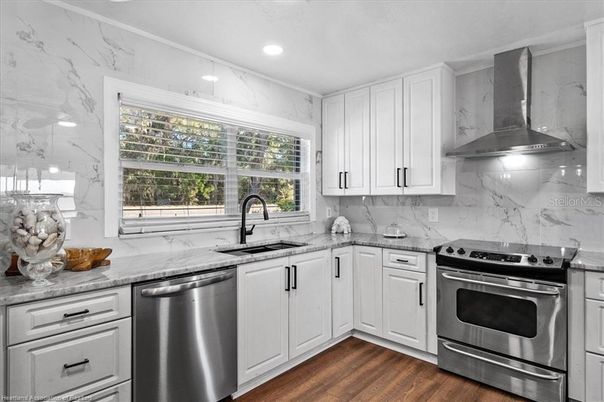 Interior, Kitchen, Marble Walls, Recessed Lighting, Stainless Steel Appliances, Wood Texture Flooring