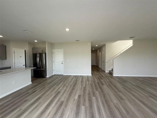 Empty room, Interior, Kitchen, Recessed Lighting, Stainless Steel Appliances, Wood Texture Flooring