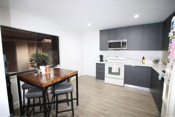 Dining room, Interior, Kitchen, Recessed Lighting, Stainless Steel Appliances, Wood Texture Flooring