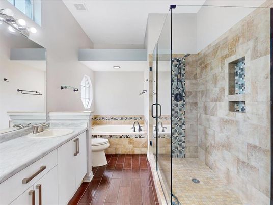 Bathroom, Dual Sink Vanities, Glass Shower, Interior, Stone Walls, Wood Texture Flooring