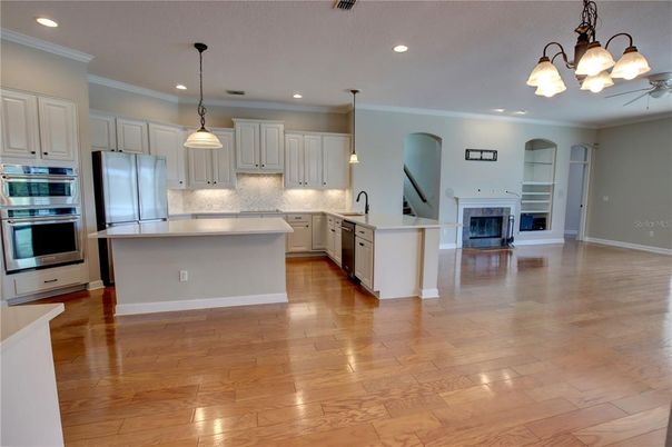 Fireplace, Interior, Kitchen, Pendant Lights, Recessed Lighting, Stainless Steel Appliances, Wood Texture Flooring
