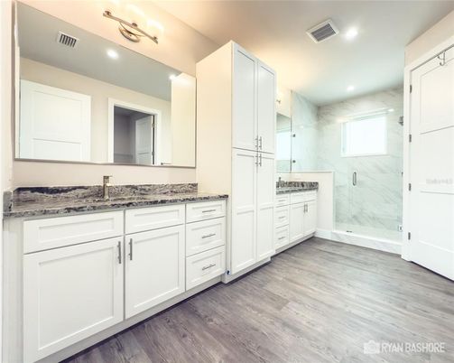 Bathroom, Dual Sink Vanities, Glass Shower, Interior, Marble Walls, Recessed Lighting, Wood Texture Flooring