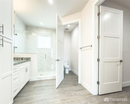 Bathroom, Glass Shower, Interior, Marble Walls, Recessed Lighting, Wood Texture Flooring