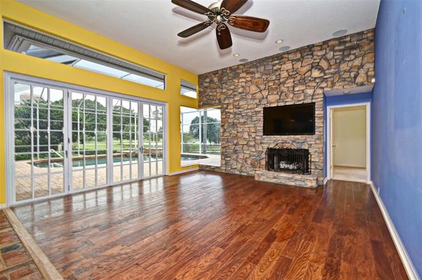 Empty room, Fireplace, Interior, Recessed Lighting, Stone Walls, Wood Texture Flooring