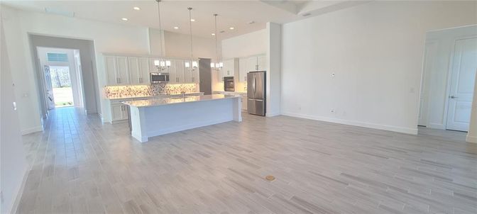 Empty room, Interior, Kitchen, Pendant Lights, Recessed Lighting, Stainless Steel Appliances, Wood Texture Flooring