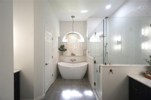 Bathroom, Chandelier, Free Standing Baths, Glass Shower, Interior, Marble Walls, Recessed Lighting, Wood Texture Flooring