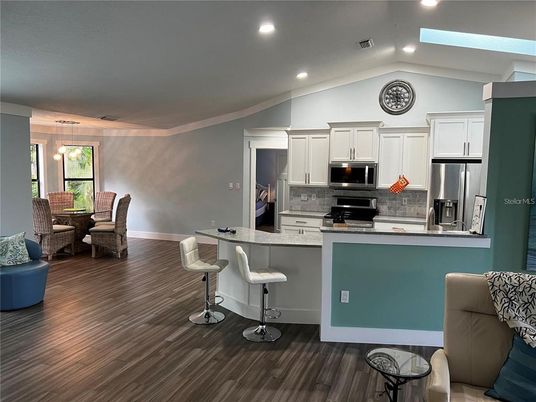 Dining room, Interior, Kitchen, Pendant Lights, Recessed Lighting, Stainless Steel Appliances, Wood Texture Flooring