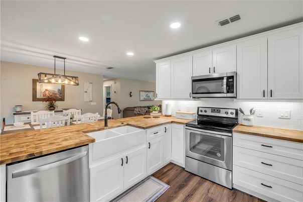 Dining room, Interior, Kitchen, Pendant Lights, Recessed Lighting, Stainless Steel Appliances, Wood Texture Flooring