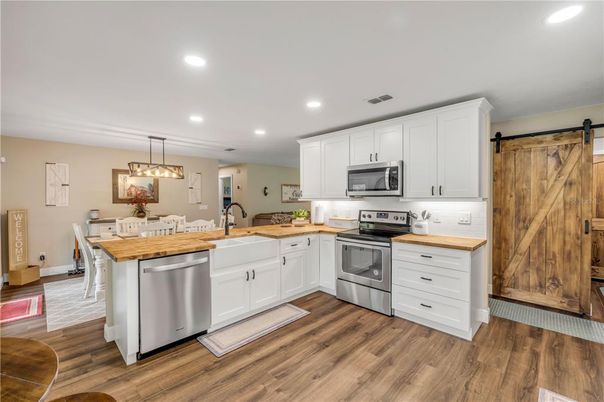 Dining room, Interior, Kitchen, Pendant Lights, Recessed Lighting, Stainless Steel Appliances, Wood Texture Flooring