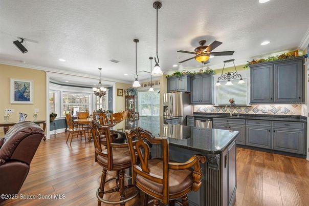 Chandelier, Dining room, Interior, Kitchen, Pendant Lights, Recessed Lighting, Stainless Steel Appliances, Wood Texture Flooring