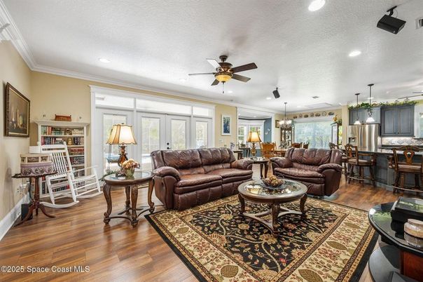 Chandelier, Dining room, Interior, Kitchen, Living room, Pendant Lights, Recessed Lighting, Stainless Steel Appliances, Wood Texture Flooring