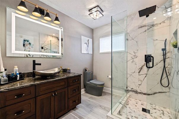 Bathroom, Dual Sink Vanities, Glass Shower, Interior, Marble Walls, Wood Texture Flooring