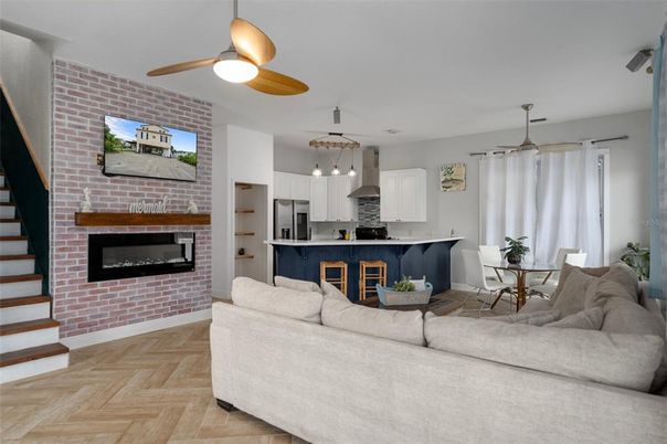 Dining room, Fireplace, Interior, Kitchen, Living room, Pendant Lights, Stainless Steel Appliances, Stone Walls, Wood Texture Flooring