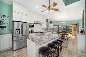 Chandelier, Dining room, Interior, Kitchen, Pendant Lights, Recessed Lighting, Stainless Steel Appliances, Wood Texture Flooring