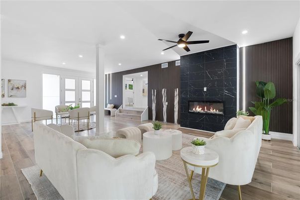 Dining room, Fireplace, Interior, Living room, Marble Walls, Recessed Lighting, Wood Texture Flooring