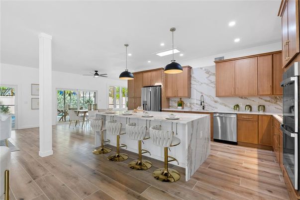 Dining room, Interior, Kitchen, Marble Walls, Pendant Lights, Recessed Lighting, Stainless Steel Appliances, Wood Texture Flooring