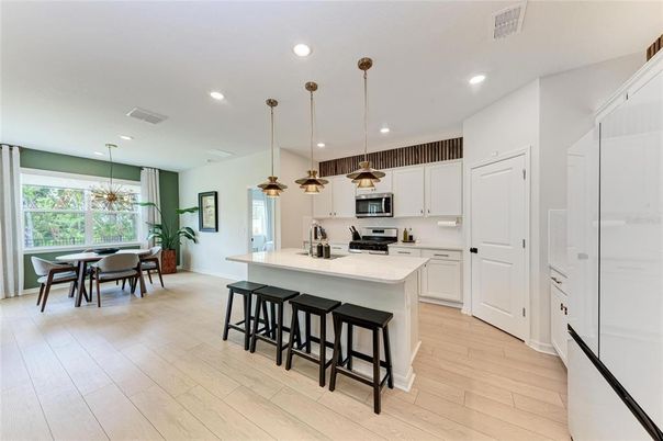 Dining room, Interior, Kitchen, Pendant Lights, Recessed Lighting, Stainless Steel Appliances, Wood Texture Flooring