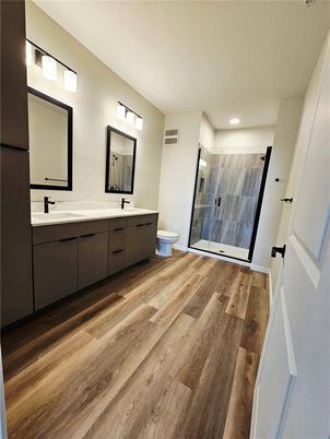 Bathroom, Dual Sink Vanities, Glass Shower, Interior, Recessed Lighting, Wood Texture Flooring