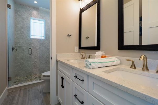 Bathroom, Dual Sink Vanities, Glass Shower, Interior, Recessed Lighting, Wood Texture Flooring