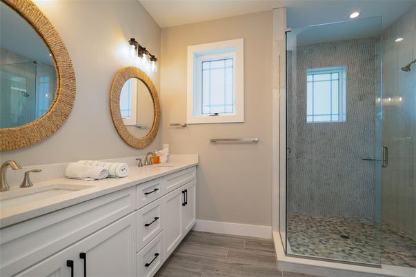 Bathroom, Dual Sink Vanities, Glass Shower, Interior, Recessed Lighting, Wood Texture Flooring
