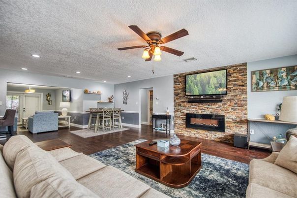 Dining room, Fireplace, Interior, Living room, Recessed Lighting, Stone Walls, Wood Texture Flooring