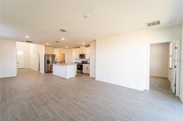 Empty room, Interior, Kitchen, Recessed Lighting, Stainless Steel Appliances, Wood Texture Flooring