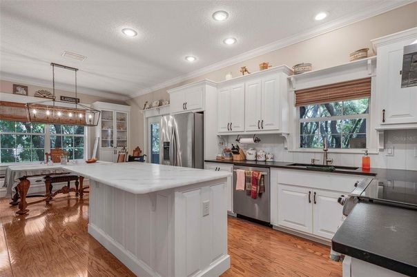Dining room, Interior, Kitchen, Pendant Lights, Recessed Lighting, Stainless Steel Appliances, Wood Texture Flooring