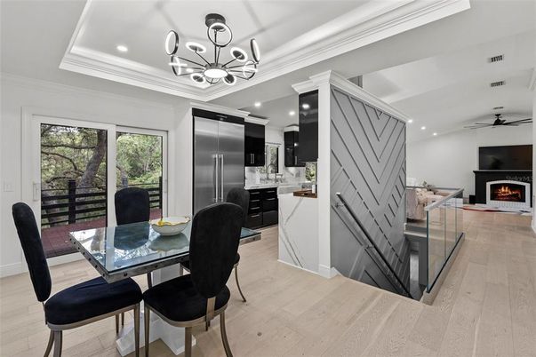 Chandelier, Dining room, Fireplace, Interior, Kitchen, Pendant Lights, Recessed Lighting, Stainless Steel Appliances, Wood Texture Flooring