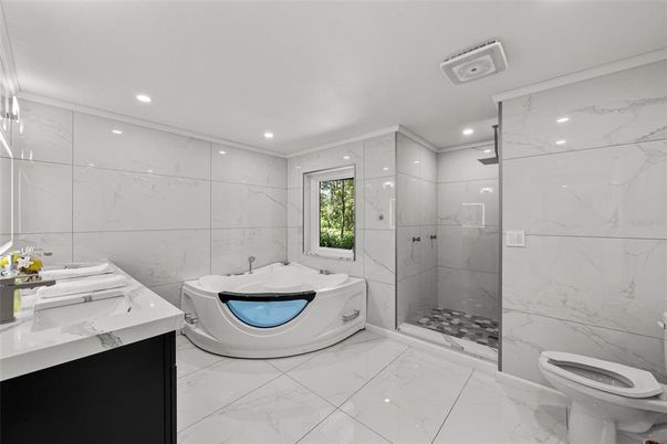 Bathroom, Dual Sink Vanities, Glass Shower, Interior, Marble, Marble Walls, Recessed Lighting