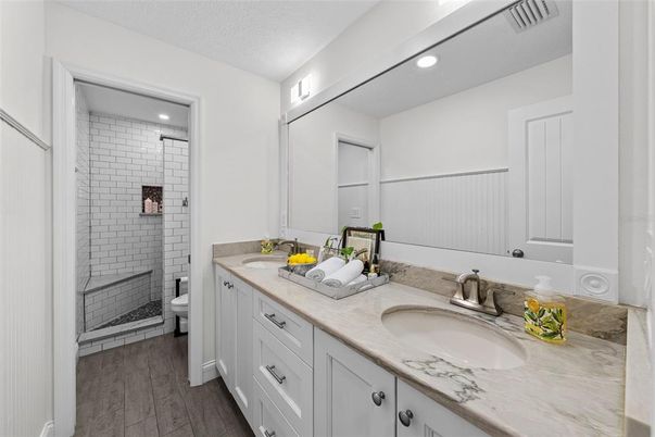 Bathroom, Dual Sink Vanities, Glass Shower, Interior, Recessed Lighting, Wood Texture Flooring