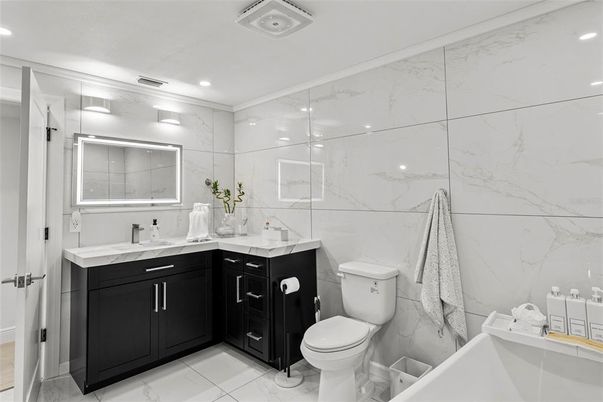 Bathroom, Dual Sink Vanities, Glass Shower, Interior, Marble, Marble Walls, Recessed Lighting