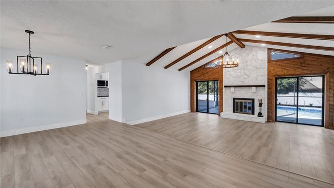 Chandelier, Empty room, Fireplace, Interior, Pendant Lights, Recessed Lighting, Wooden Beams, Wood Texture Flooring