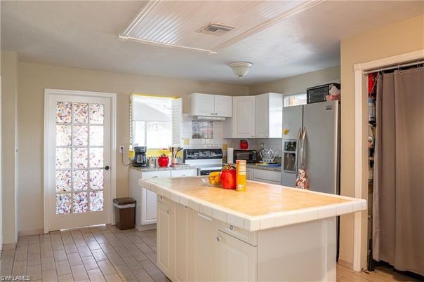 Interior, Kitchen, Stainless Steel Appliances, Tile Countertops, Wood Texture Flooring