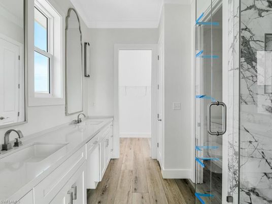 Bathroom, Dual Sink Vanities, Glass Shower, Interior, Marble Walls, Wood Texture Flooring