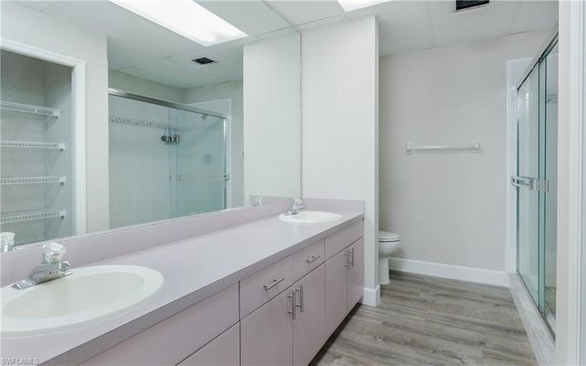 Bathroom, Dual Sink Vanities, Glass Shower, Interior, Walk-in Closets, Wood Texture Flooring