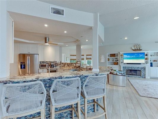 Fireplace, Interior, Kitchen, Recessed Lighting, Stainless Steel Appliances, Wood Texture Flooring